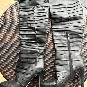 Black leather knee high boots 4 inch heel side buckle side zipper.